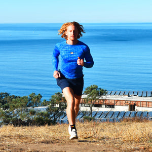 Person running on a path with a scenic ocean view